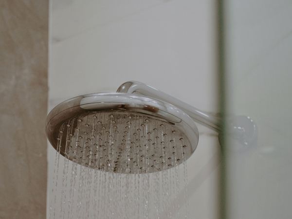 Shower head running with hot water