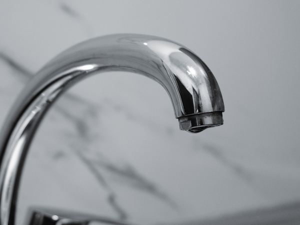 Chrome tap spout against marble